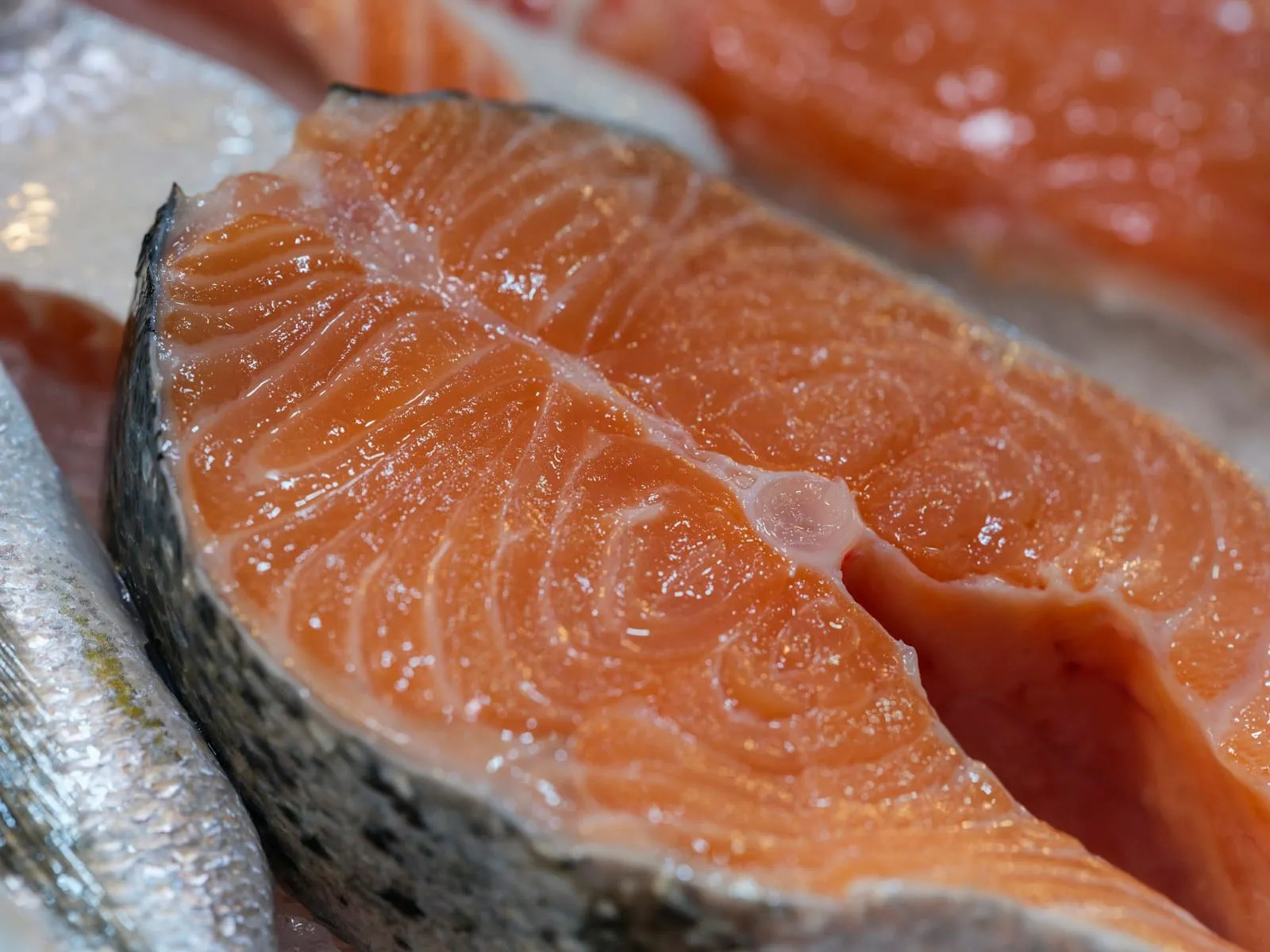 A close-up of a raw salmon steak.